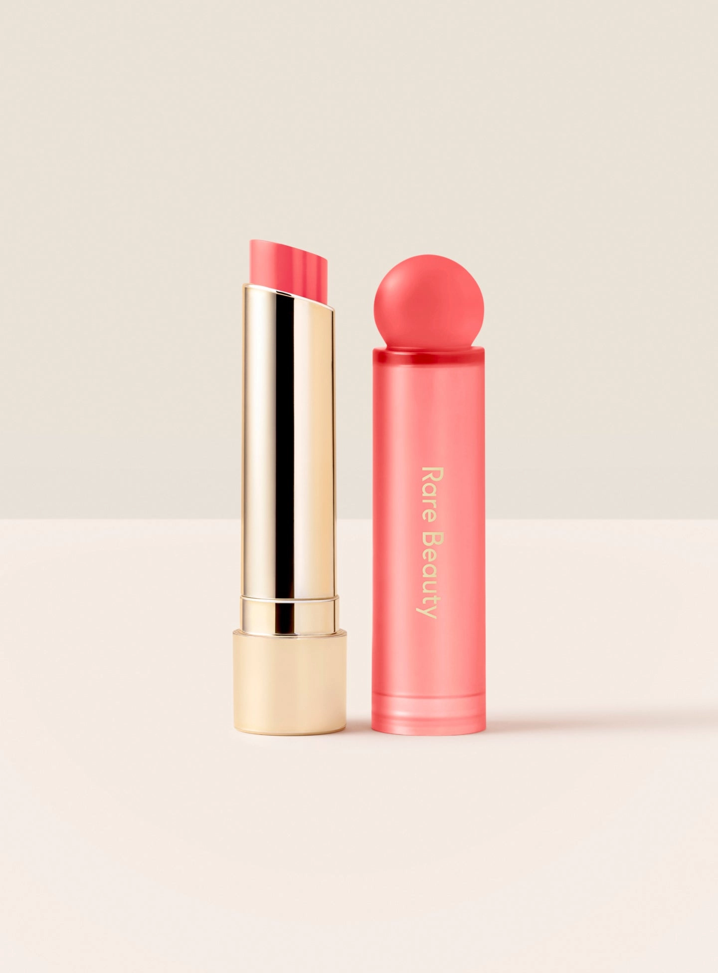 Open Soft Pinch Lip Oil Stick in Wish, a bright coral shade