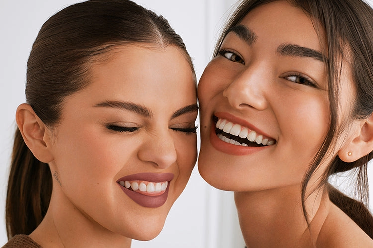 Two friends smiling, close up